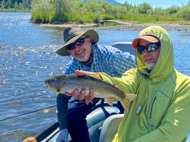 Greg with a nice cuttbow that survived a previous osprey encounter - Clark Fork Fly Fishing July
