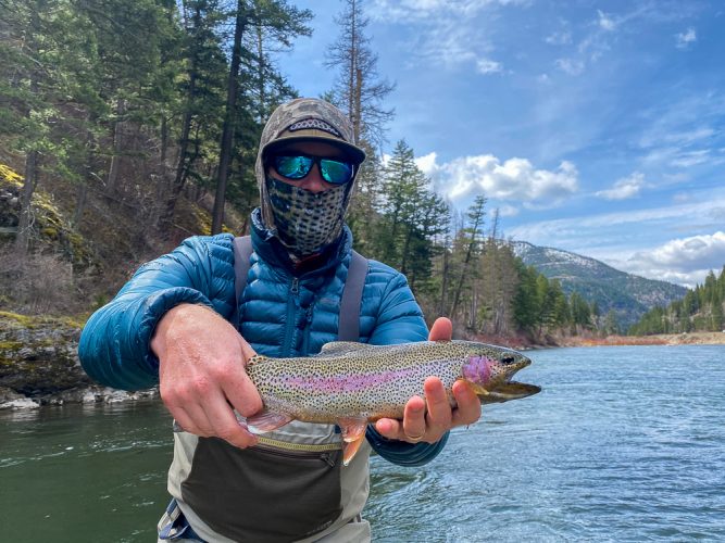 Bradley with a gorgeous rainbow and impressive view- Flyfishing Montana 2022