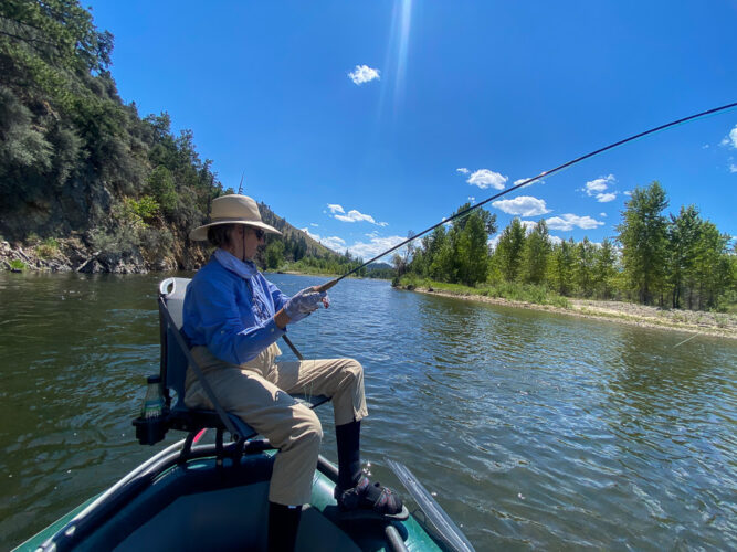 Cindi hooked up in the back of the boat in the afternoon - Hoot Owl Trout Fishing