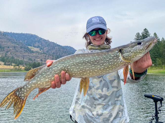 Izzy was all smiles at the end of he day with a pike of her own - Spruce Moth Hatch Fishing