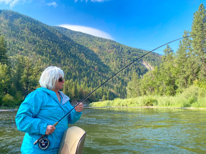 Lois hooked up to a dry fly trout - Early Morning Fly Fishing