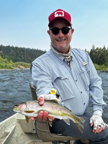 Wesley with a bright rainbow early - Montana Trout Fishing July Report