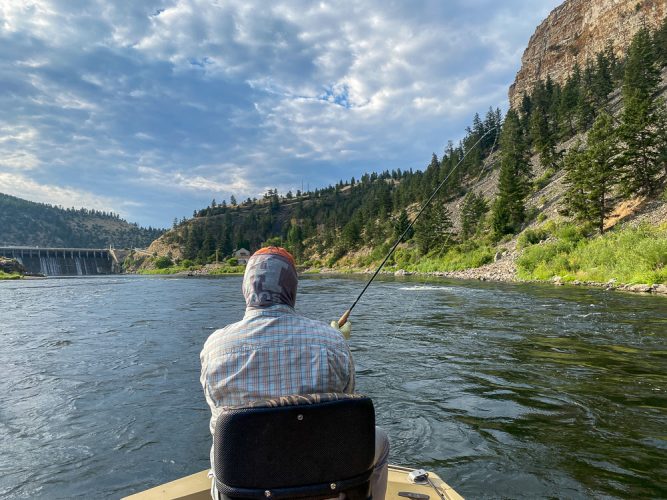 Bob with a fish charging hard upstream in fast water - Best Montana Fishing